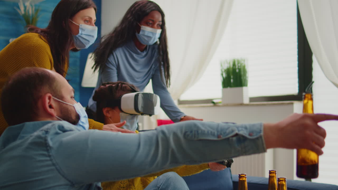 Friends supporting woman during video game playing with vr goggles