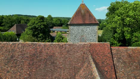 crawling boom-shot of the roof and tower of st lawrence the martyr church in godmersham, kent