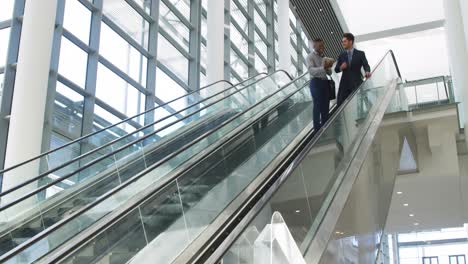 young business people on an escalator in a modern building