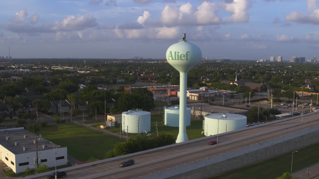 Drone View Over Alief District in Houston Highlighting Water Tank near Toll Road