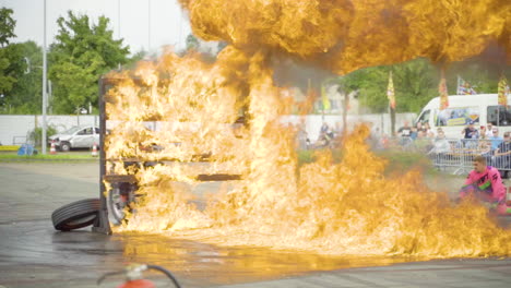 stuntman breaking through a fiery wooden wall during a show in germany -wide