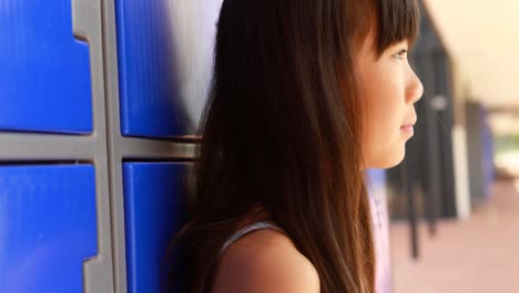 thoughtful girl sitting in locker room 4k