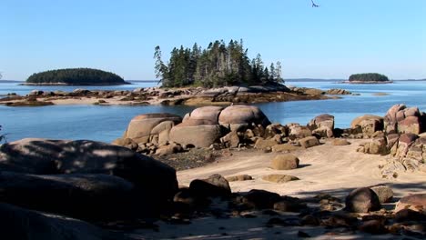 water moves between small islands offshore a lobster village in stonington maine