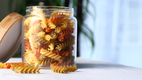 colorful spiral pasta in a glass jar