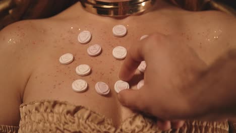 Pills Taken from a Woman&#039;s Body by Men&#039;s Hands