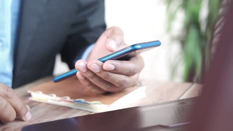 businessman using smartphone at his desk