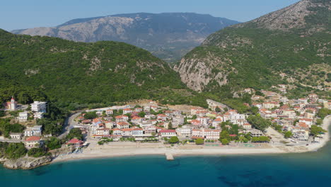 poros village and port in kefalonia seen in panoramic drone video, with calm waters and lush green hills
