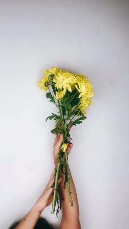 yellow chrysanthemum bouquet in hands