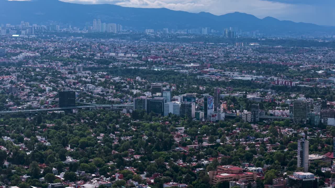 Drone film of Mexico City's west side on a clear, bustling day