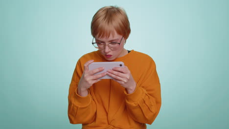 worried funny addicted tourist girl enthusiastically playing drive racing video game on mobile phone