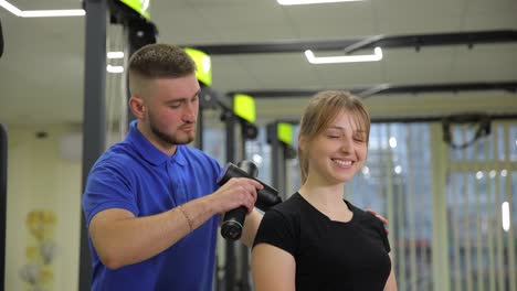 a gym where a man gives a woman a soothing shoulder massage a tranquil gym where a man gives a relaxing shoulder massage to a woman highlighting selfcare and physical wellness in fitness