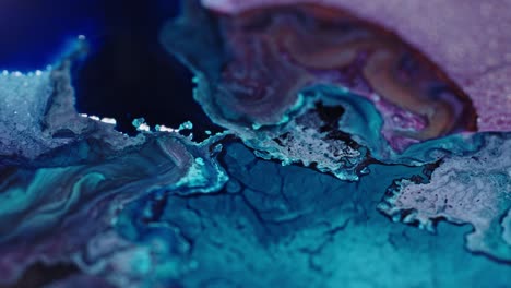 close-up of vibrant blue and pink ink diffusing in water, creating an abstract pattern