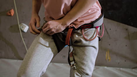 Boy-putting-on-a-harness-indoors