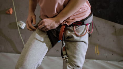 boy putting on a harness indoors