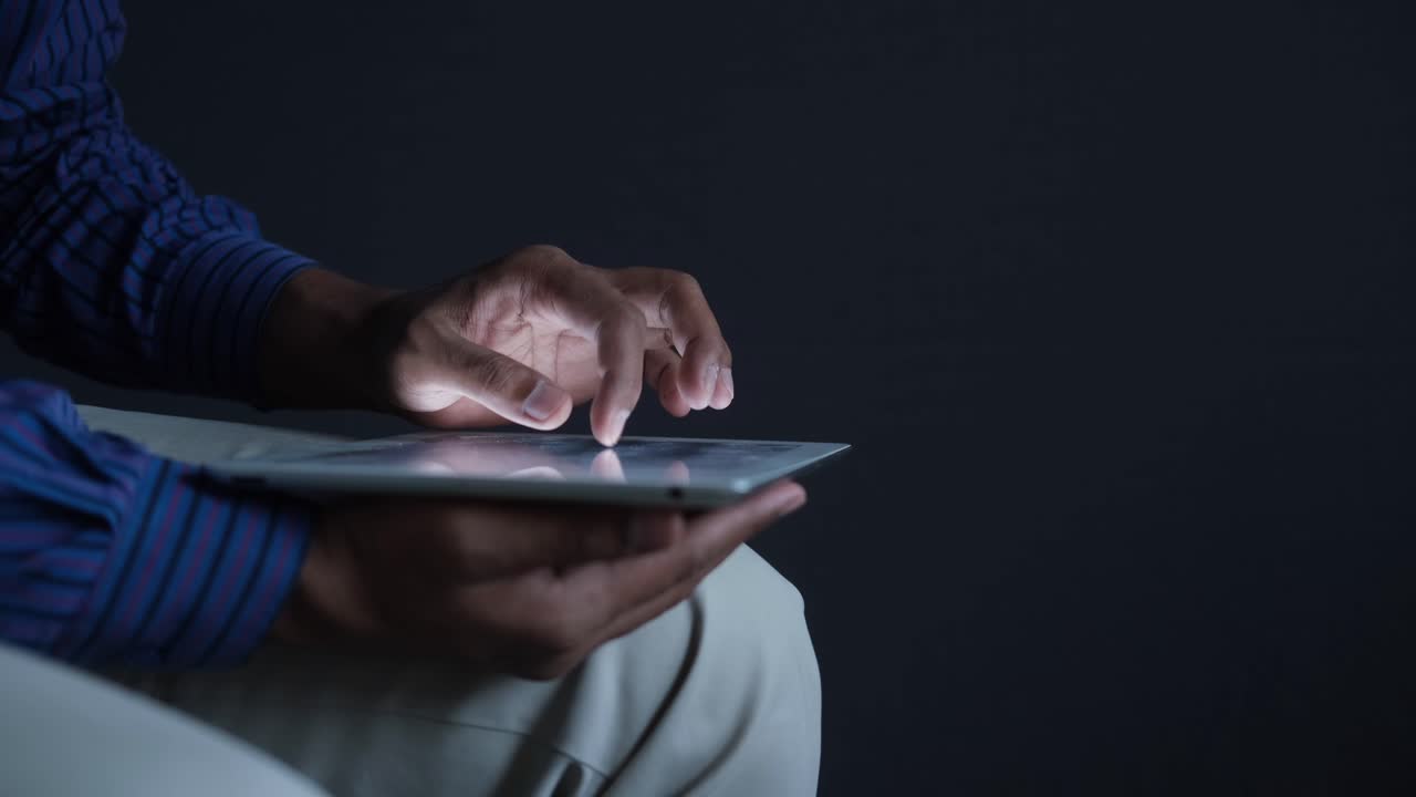Person using a tablet at night