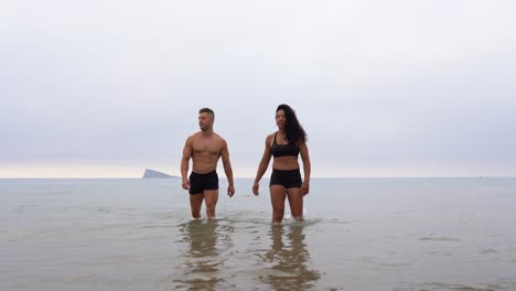 multiethnic sportspeople on beach during training