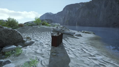 a lone suitcase on a beach with mountains in the background