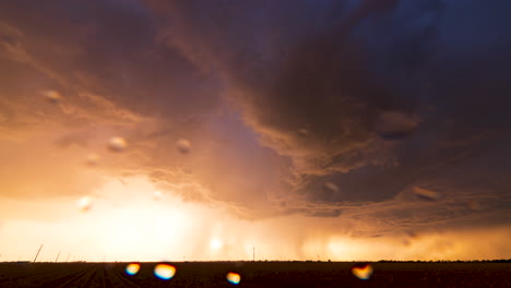 sun illuminates the underside of a thunderstorm as it rages onward in texas