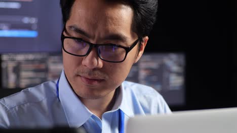 man working on a laptop at night