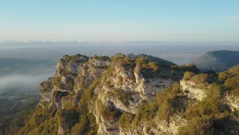 drone flight next to cliffs in mallorca - beautiful landscape at sunrise - spanish city llucmajor in the background - balearic islands spain