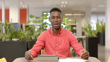 Portrait-of-casual-african-american-businessman-on-video-call-in-office,-slow-motion-with-copy-space