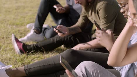 group of focused young people using smartphones.