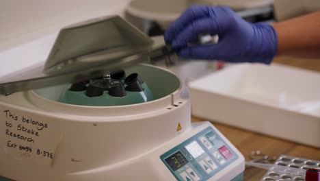 blood analysis in action uk doctor using centrifuge machine