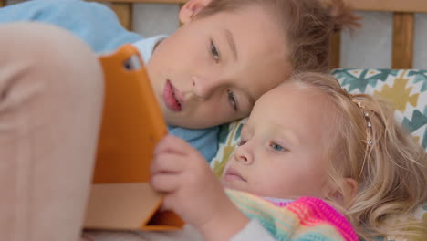 Older-brother-plays-with-his-sister-on-a-laptop