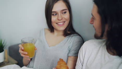 pareja disfrutando del desayuno en la cama