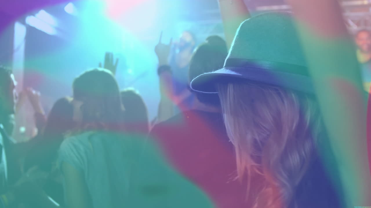 Concert crowd raising hands during entertainment marketing, showing animated charts and light icons