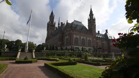 garden of the peace palace, the seat of the international court of justice under a sunny and cloudy summer day.