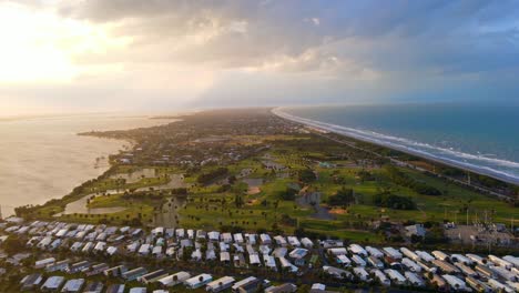 A-calm-4k-drone-shot-of-buildings-and-homes-on-an-island-with-palm-trees-and-tropical-landscape