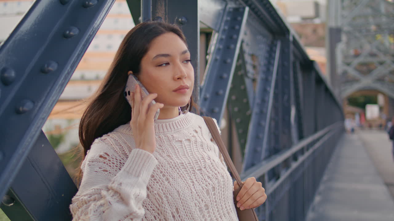Woman looking smartphone screen waiting friend at river bridge closeup