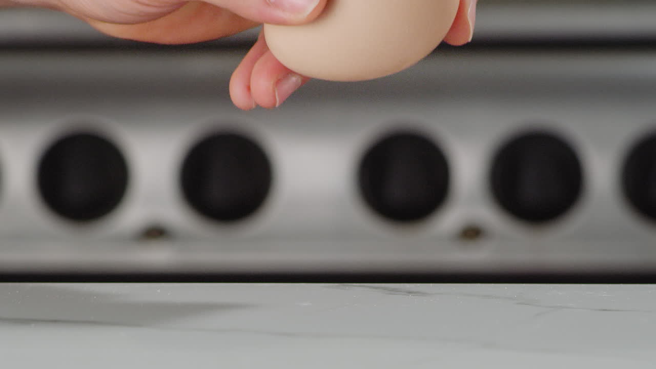 Cracking an egg on a counter top