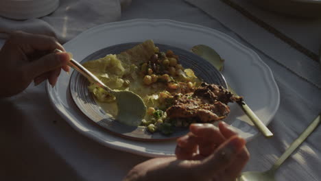 close-up of hands eating a delicious meal