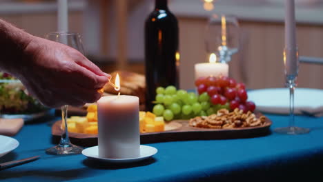 Close-up-of-man-lighting-the-candle