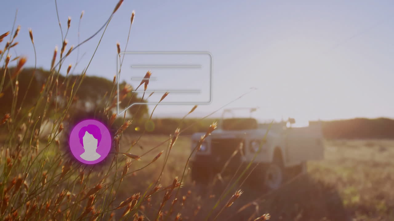 Silhouette of vehicle in field with social media notification animation over grass