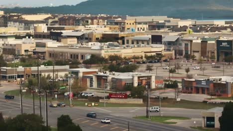 outdoor shopping mall in austin texas, hill country galleria in lakeway bee caves, aerial drone rise up at sunrise in 4k