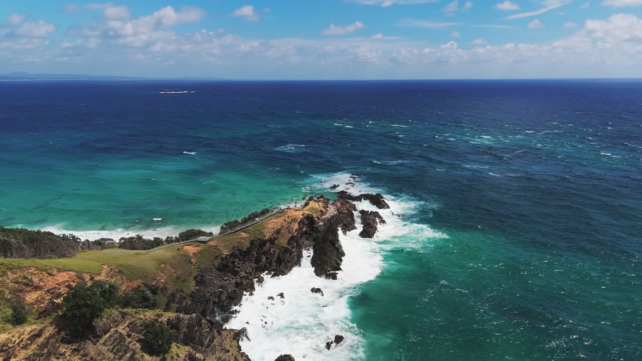 Breathtaking drone view of Byron bay’s coastline, rocky cliffs and vibrant blue ocean, travel and surf destination in Australia.