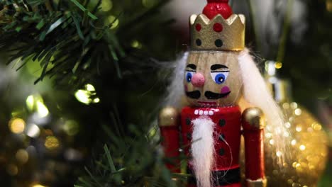 red nutcracker decoration on a green christmas tree