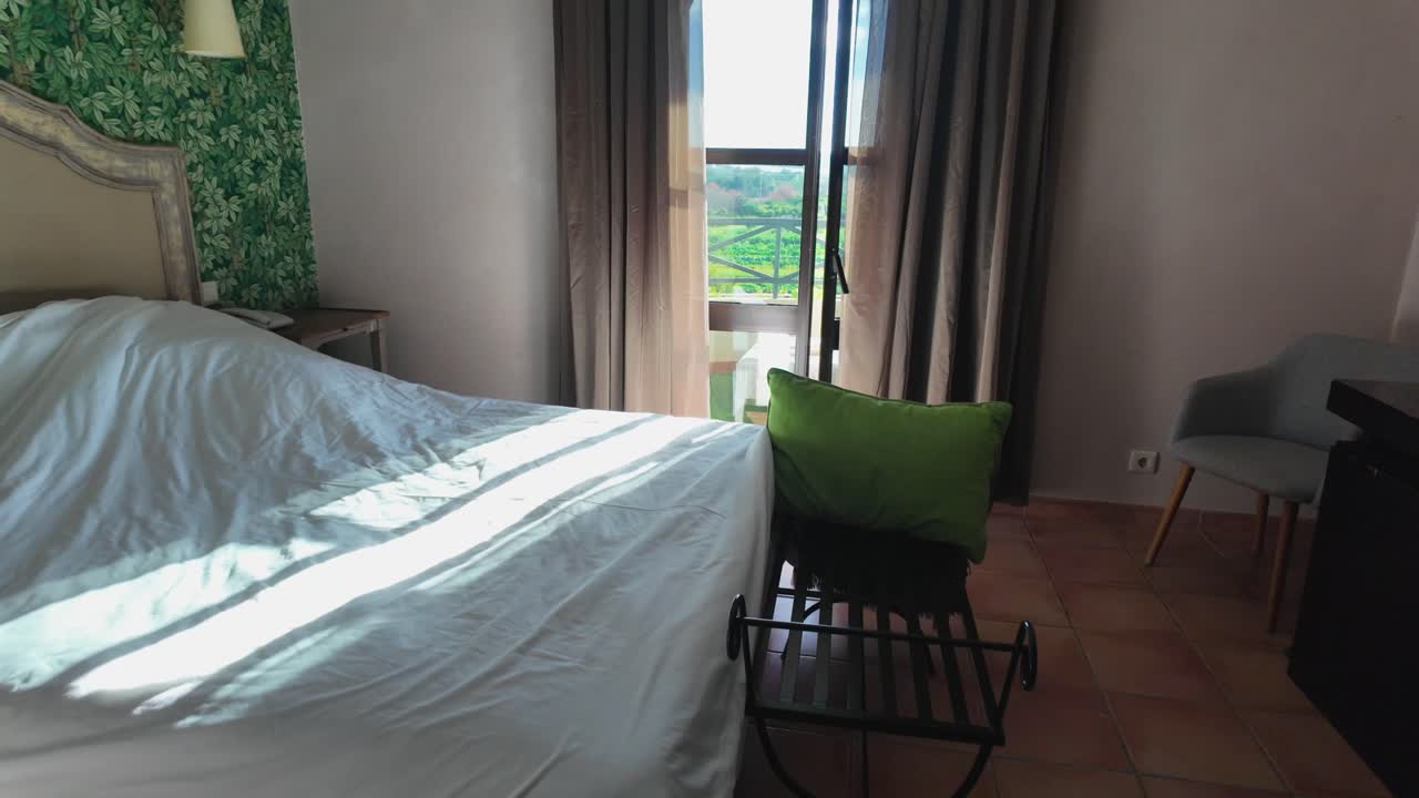 Slow-motion sunny bedroom with nature view through window