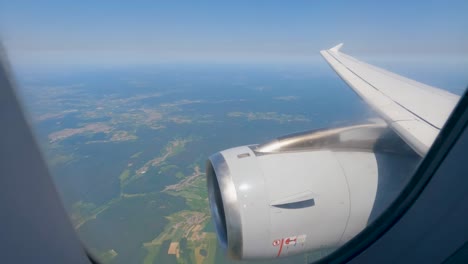 Airplane-windows-in-flight-turbine-in-closeup-Full-view-of-the-plane-in-flight