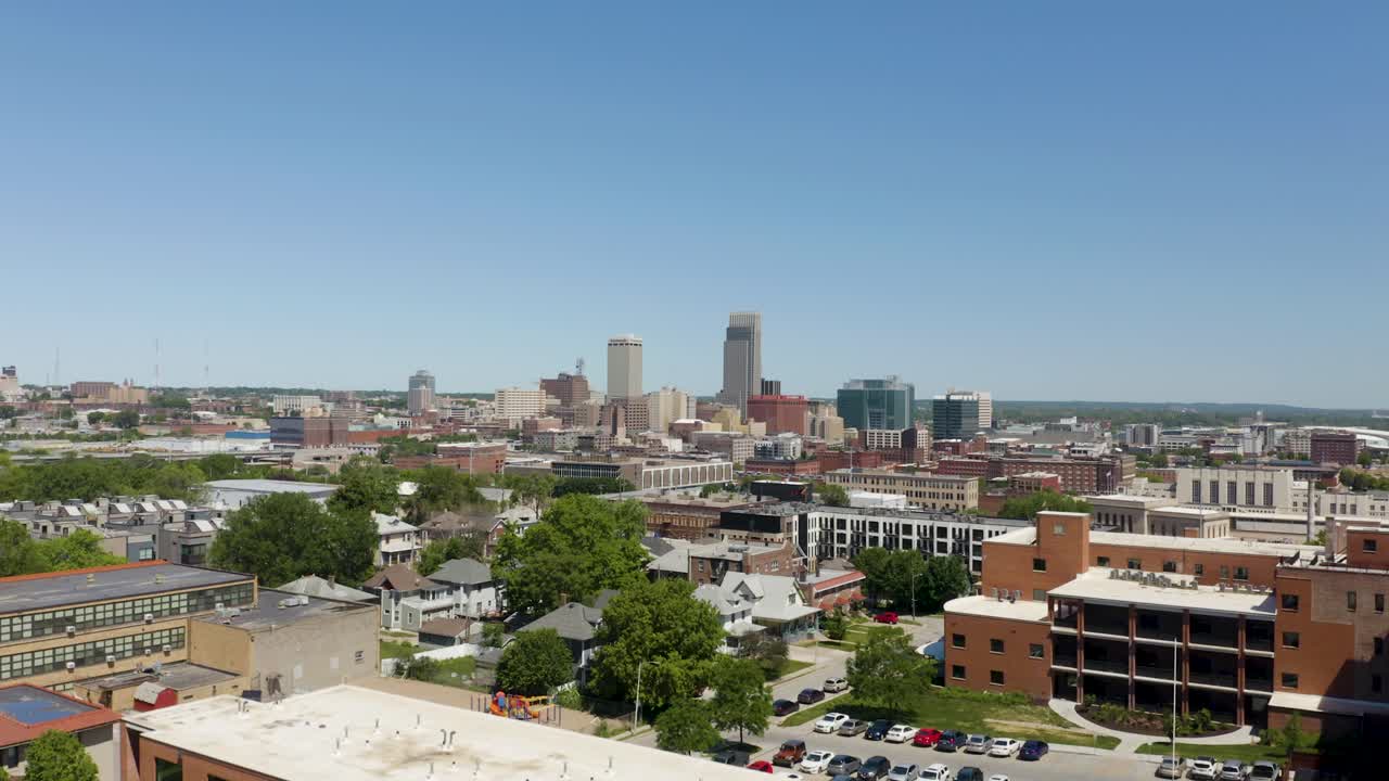 Un movimento verticale rivela lo skyline di Omaha dietro un edificio residenziale.