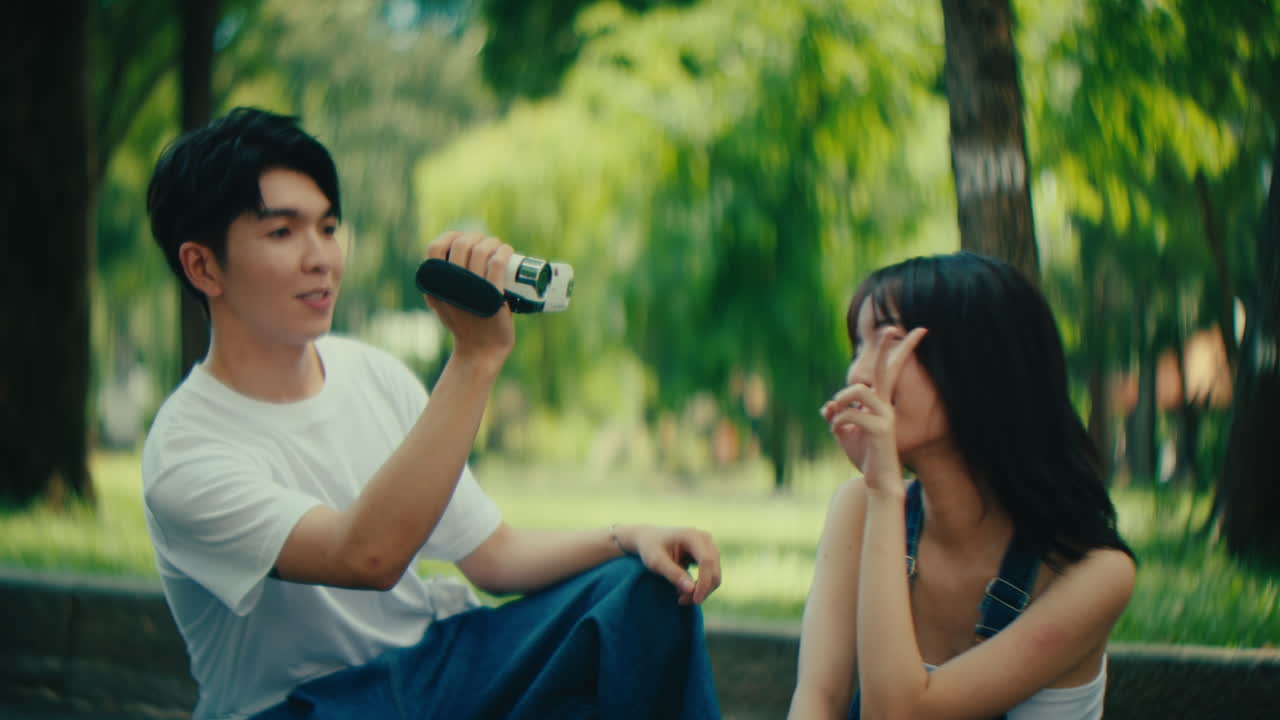 Couple Recording Video in Park