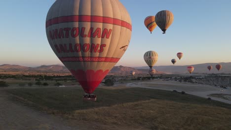 aerial view of hot air balloon inflating in the sky, very popular tourist entertainment for turkey cappadocia, nevsehir hot air balloon tours in the skyscape