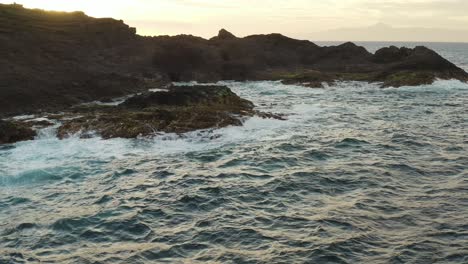 Drone-shot-of-waves-splashing-on-the-coast-of-an-ocean