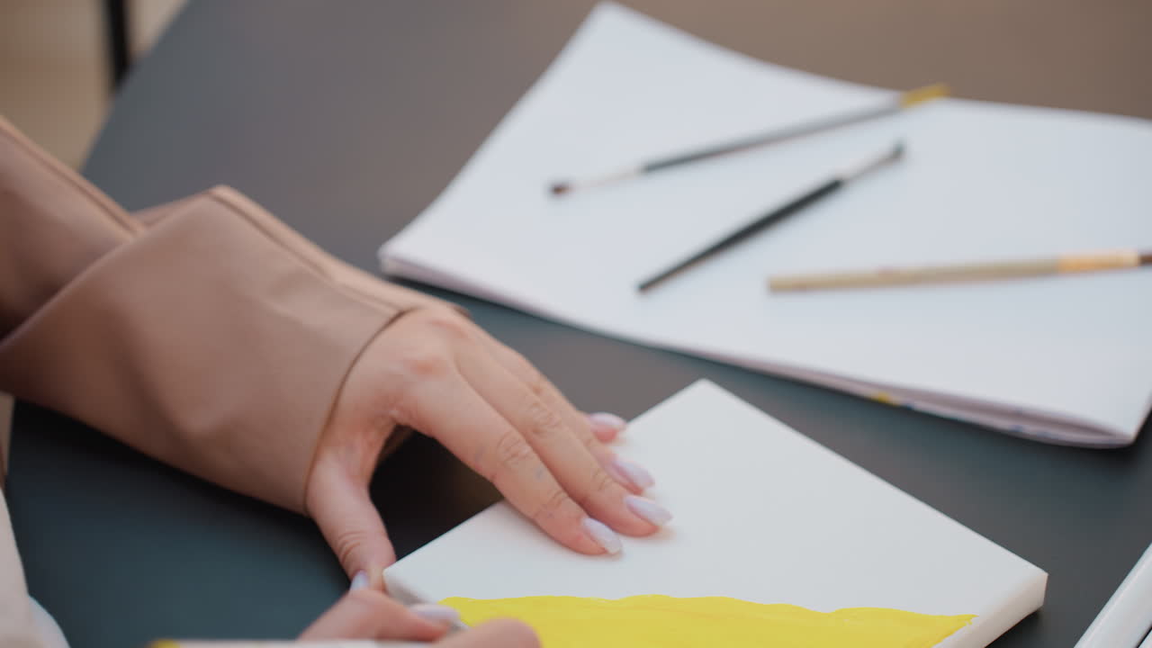 artisan skillfully merges colors with subtlety, creative individual applies delicate strokes for visual harmony, artist uses gentle techniques to achieve refined and harmonious composition