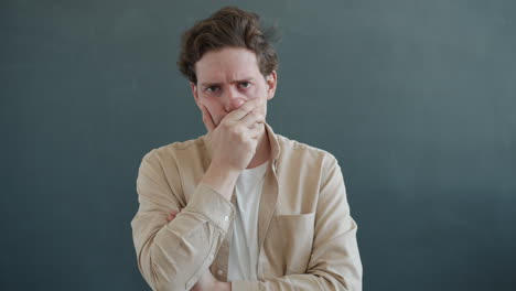 man with arms crossed looking displeased