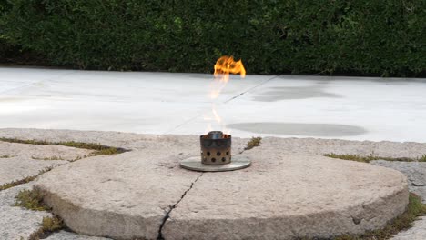 Pan-slow-motion-shot-of-the-Eternal-Flame-over-the-grave-of-JFK-at-Arlington-National-Cemetery