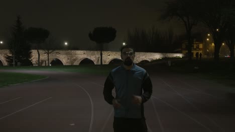 athletic person warming up on terrain before start jogging, aqueducts in background